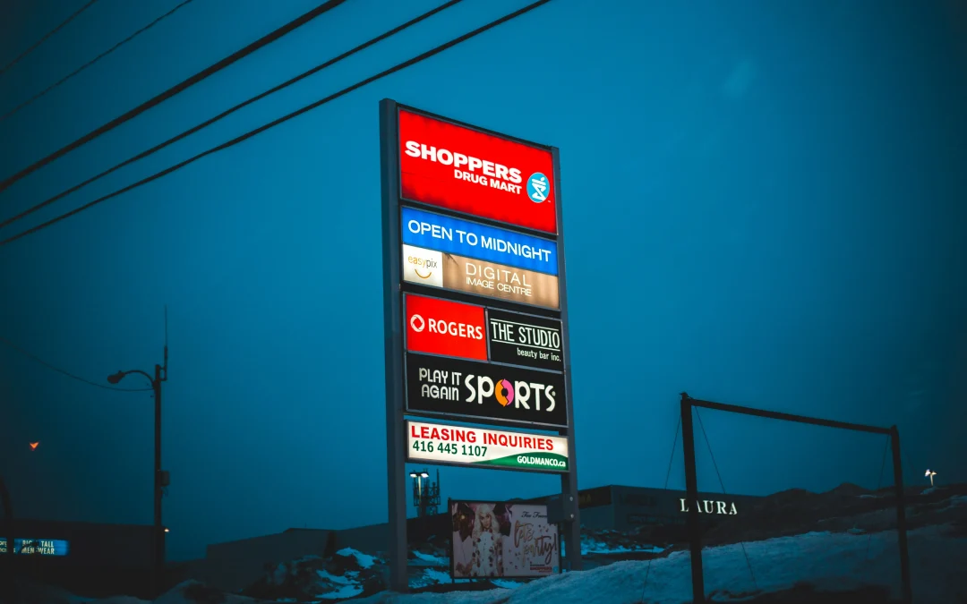 Illuminated pylon sign for commercial plaza in Ottawa during winter-multi-tenant retail signage